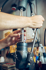 Image showing Different goldsmiths tools on the jewelry workplace. Jeweler at work in jewelry.