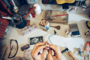 Image showing Different goldsmiths tools on the jewelry workplace. Jeweler at work in jewelry.