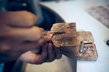 Image showing Different goldsmiths tools on the jewelry workplace. Jeweler at work in jewelry.