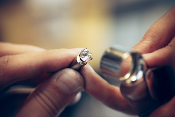 Image showing Different goldsmiths tools on the jewelry workplace. Jeweler at work in jewelry.