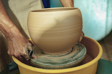 Image showing Creating a jar or vase of white clay close-up. Master crock.