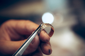 Image showing Different goldsmiths tools on the jewelry workplace. Jeweler at work in jewelry.