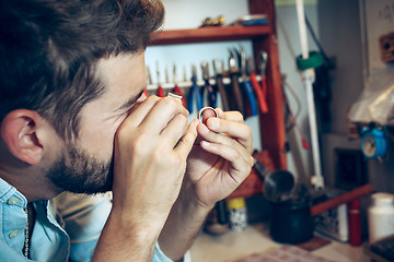 Image showing Different goldsmiths tools on the jewelry workplace. Jeweler at work in jewelry.