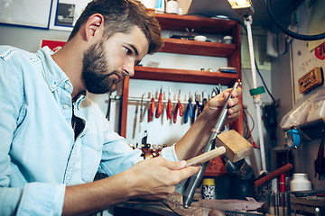 Image showing Different goldsmiths tools on the jewelry workplace. Jeweler at work in jewelry.