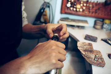 Image showing Different goldsmiths tools on the jewelry workplace. Jeweler at work in jewelry.