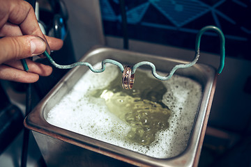 Image showing Different goldsmiths tools on the jewelry workplace. Jeweler at work in jewelry.