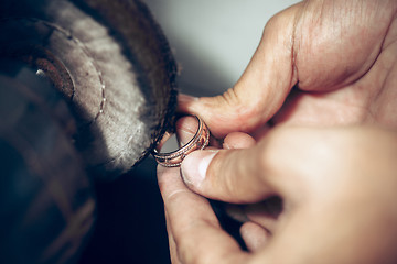 Image showing Different goldsmiths tools on the jewelry workplace. Jeweler at work in jewelry.