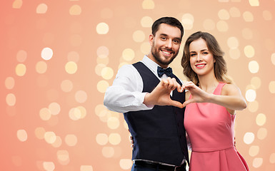 Image showing happy couple making hand heart on valentines day