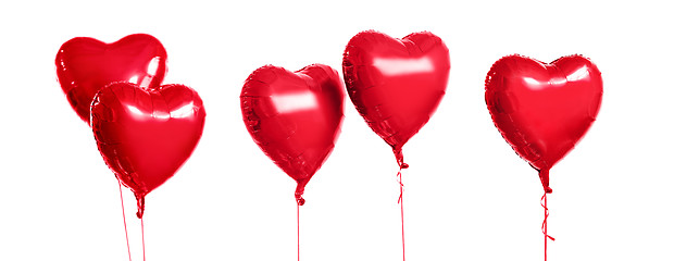 Image showing five red heart shaped helium balloons on white