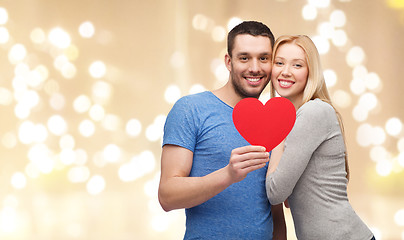 Image showing happy couple with red heart over festive lights