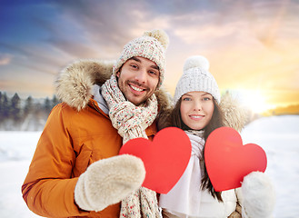 Image showing happy couple with red hearts over winter nature