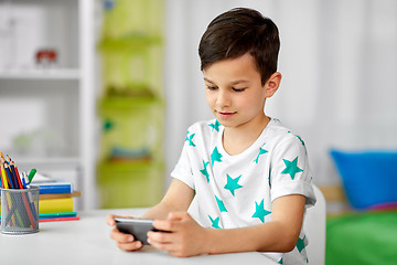 Image showing happy boy with smartphone at home