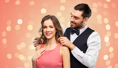 Image showing happy man puts necklace on his girlfriend