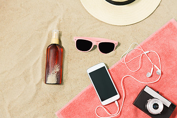 Image showing smartphone, camera, towel, hat and shades on beach