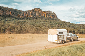 Image showing Horse float pulled by four wheel drive along a dirt road in rural Australia