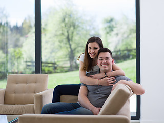 Image showing young handsome couple hugging on the sofa