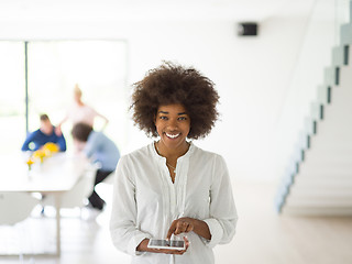 Image showing Portrait of  black casual businesswoman using tablet  with cowor