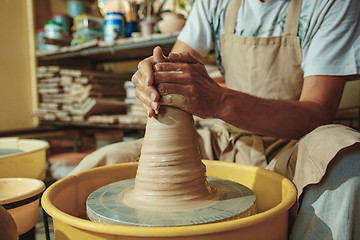 Image showing Creating a jar or vase of white clay close-up. Master crock.