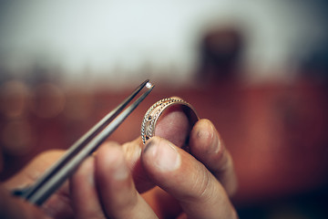 Image showing Different goldsmiths tools on the jewelry workplace. Jeweler at work in jewelry.