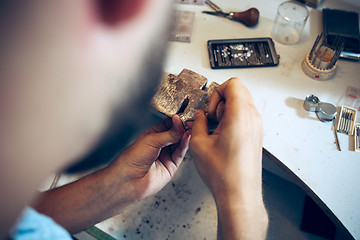 Image showing Different goldsmiths tools on the jewelry workplace. Jeweler at work in jewelry.