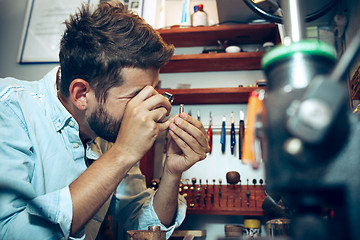 Image showing Different goldsmiths tools on the jewelry workplace. Jeweler at work in jewelry.