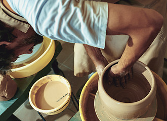 Image showing Creating a jar or vase of white clay close-up. Master crock.