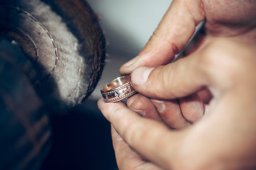 Image showing Different goldsmiths tools on the jewelry workplace. Jeweler at work in jewelry.