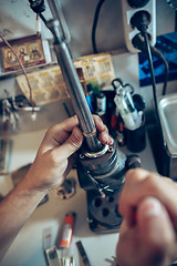 Image showing Different goldsmiths tools on the jewelry workplace. Jeweler at work in jewelry.