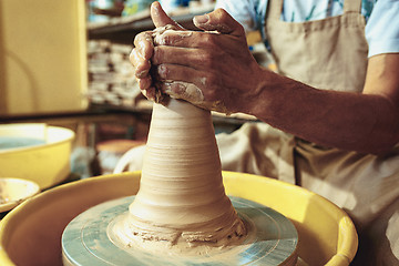 Image showing Creating a jar or vase of white clay close-up. Master crock.