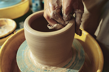Image showing Creating a jar or vase of white clay close-up. Master crock.