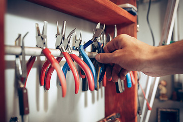 Image showing Different goldsmiths tools on the jewelry workplace. work in jewelry.