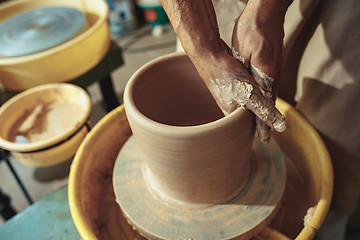 Image showing Creating a jar or vase of white clay close-up. Master crock.