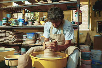 Image showing Creating a jar or vase of white clay close-up. Master crock.