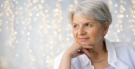 Image showing portrait of senior woman over festive lights