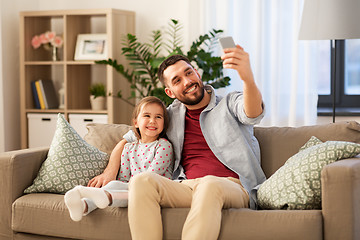 Image showing father and daughter taking selfie at home