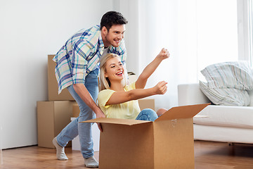 Image showing happy couple having fun with box at new home