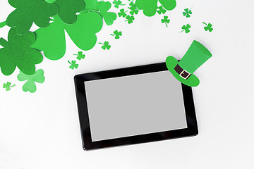 Image showing tablet pc and st patricks day decorations on white