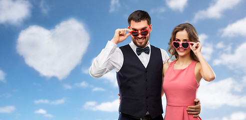 Image showing happy couple in heart-shaped sunglasses