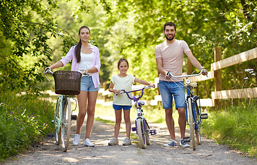 Image showing happy family with bicycles in summer park