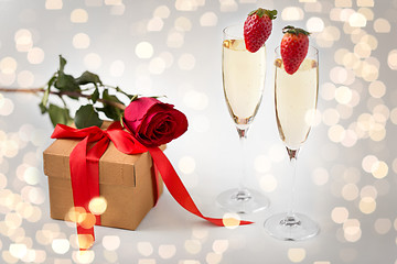 Image showing two champagne glasses and gift with red rose