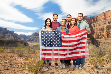 Image showing friends with american flag over grand canyon