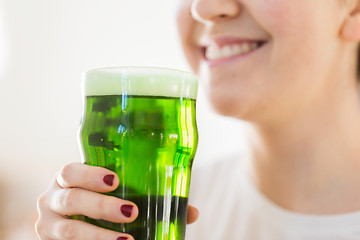 Image showing close up of woman with green beer in glass