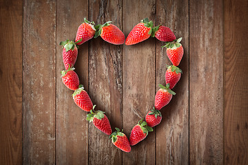 Image showing heart shaped frame made of fresh strawberries