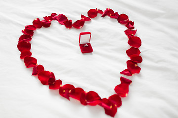 Image showing heart made of petals and diamond ring in gift box