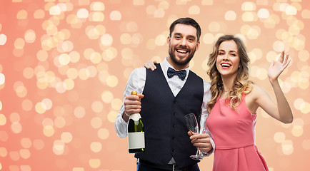 Image showing happy couple with bottle of champagne and glasses