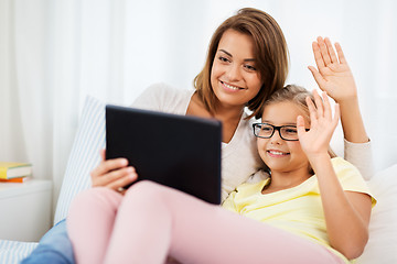 Image showing happy mother and daughter with tablet pc at home