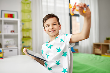 Image showing boy with tablet computer and toy airplane at home