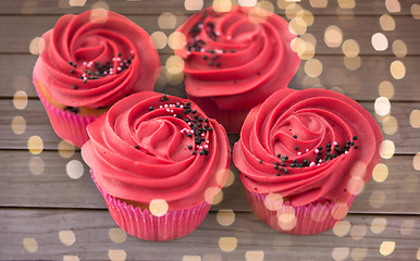 Image showing close up of cupcakes with red buttercream frosting