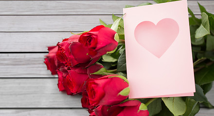 Image showing close up of red roses and greeting card with heart