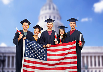 Image showing graduate students with diplomas and american flag